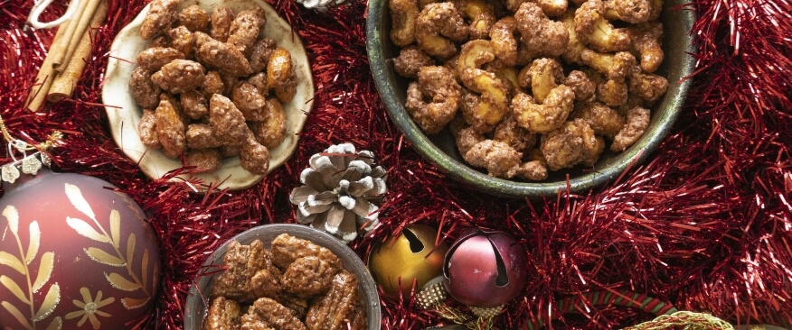 Cinnamon roasted nutz in bowls arranged in a christmas scene
